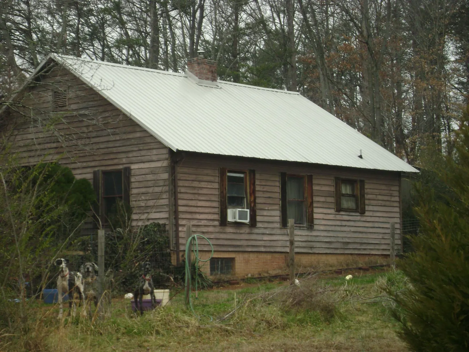 White metal roof on an old wood sided farmhouse, from a Metal Roof Installation job in Winchendon